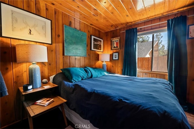 bedroom with wood ceiling and wooden walls