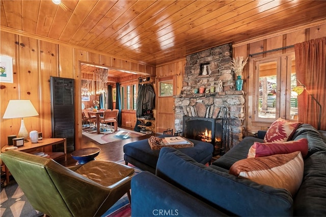 living room featuring wooden ceiling, a fireplace, wood finished floors, and wood walls