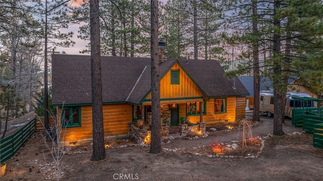 view of front of home featuring crawl space, roof with shingles, and a chimney