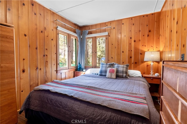 bedroom with wood walls