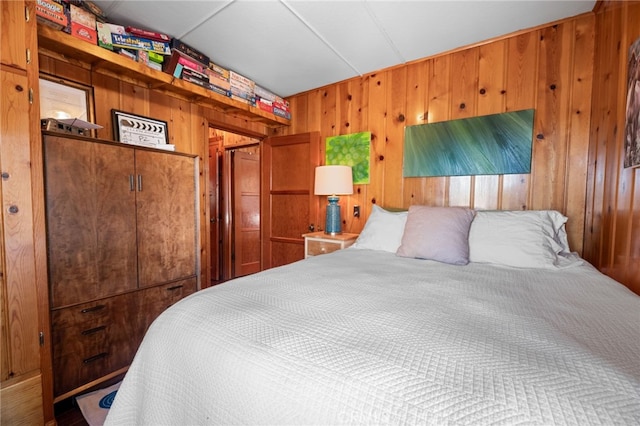 bedroom featuring wood walls