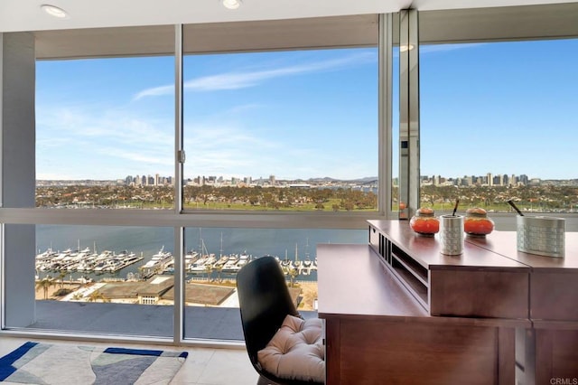 interior space featuring a view of city, plenty of natural light, and a water view