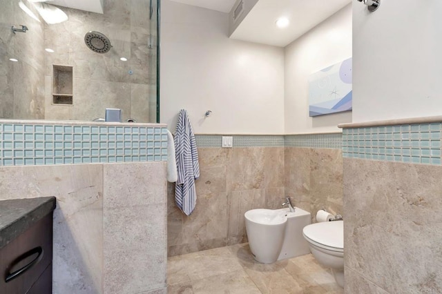 full bathroom with visible vents, a walk in shower, a wainscoted wall, toilet, and a bidet