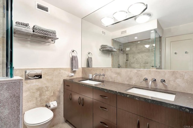 full bathroom with a stall shower, visible vents, and a sink