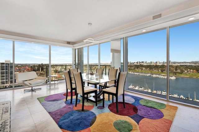 sunroom / solarium featuring a water view