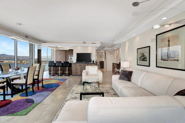 living area with light tile patterned floors, recessed lighting, and a mountain view