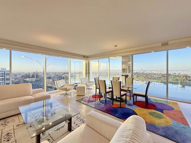 sunroom with a city view and a water view