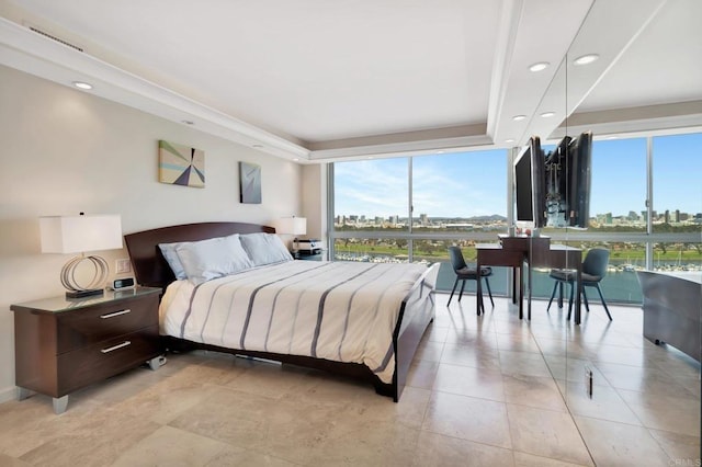 bedroom with a raised ceiling, light tile patterned flooring, and recessed lighting