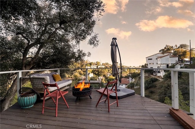 wooden deck with an outdoor fire pit