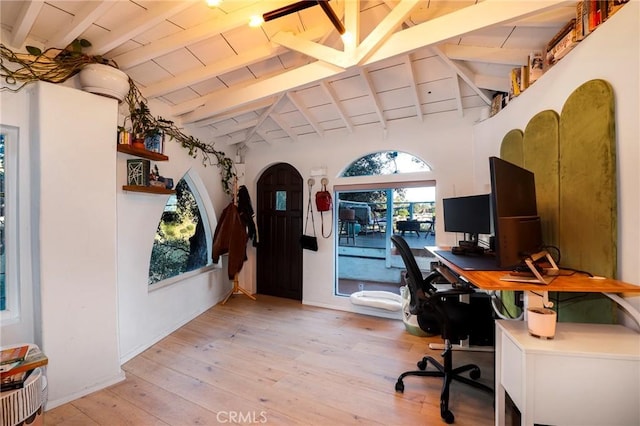 office area featuring lofted ceiling with beams, arched walkways, wood ceiling, and light wood finished floors