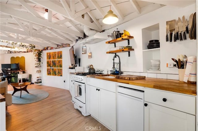 kitchen featuring vaulted ceiling with beams, light wood-type flooring, white gas range, wood counters, and a sink