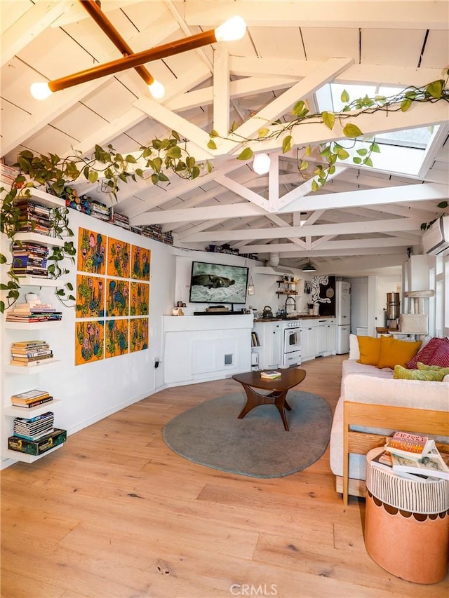 living room featuring light wood-type flooring, lofted ceiling with skylight, and an AC wall unit