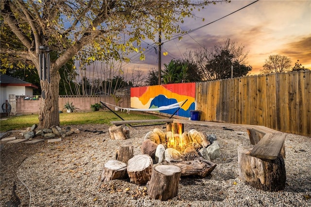 yard at dusk with a fenced backyard