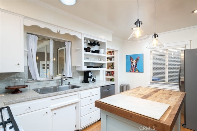 kitchen featuring a sink, white cabinets, hanging light fixtures, appliances with stainless steel finishes, and open shelves