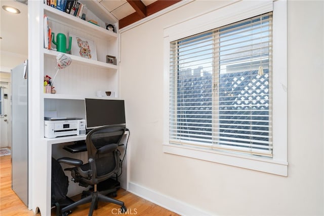 office with light wood-type flooring and baseboards