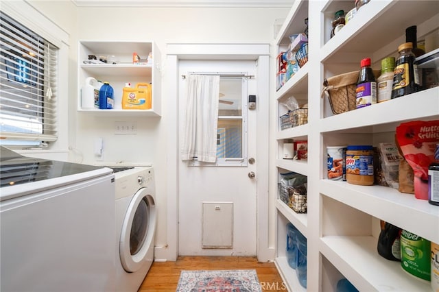 laundry room featuring light wood-style floors, laundry area, and independent washer and dryer