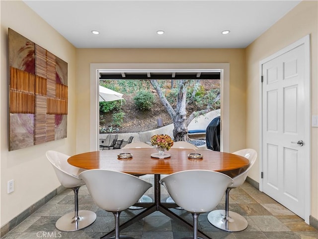 dining area with a healthy amount of sunlight, stone tile floors, baseboards, and recessed lighting