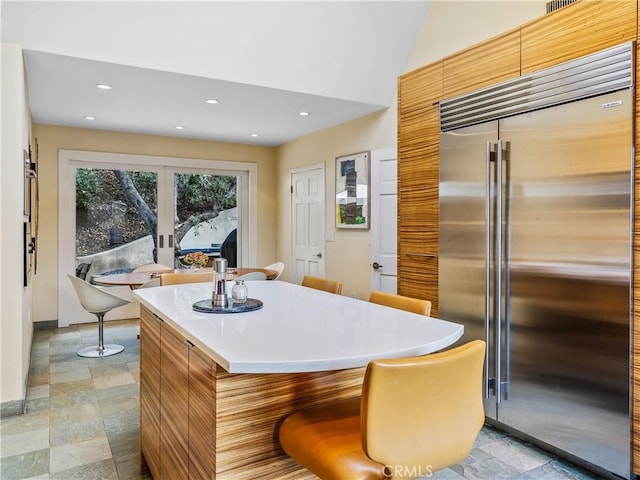 kitchen with light countertops, recessed lighting, modern cabinets, and stainless steel built in fridge