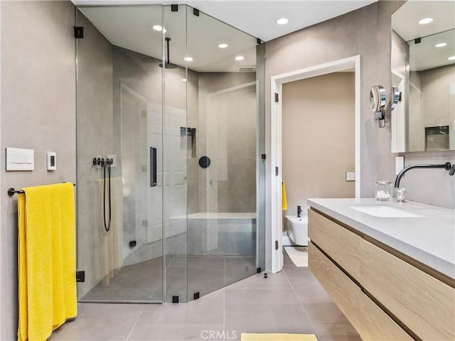 full bathroom with tile patterned flooring, vanity, a shower stall, and recessed lighting