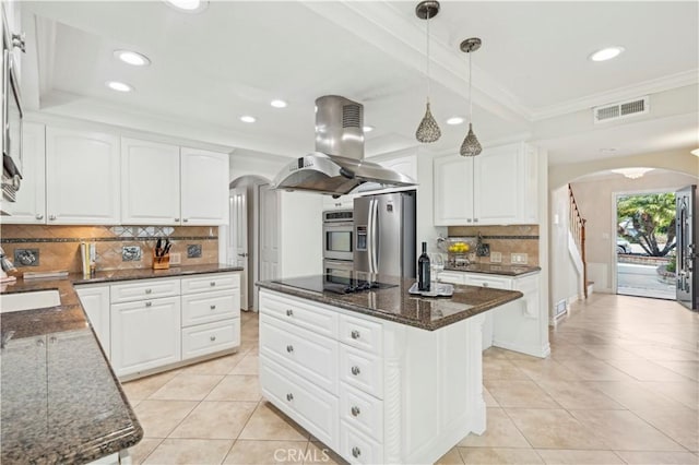 1632 Indus St, Newport Beach, CA 92660 - kitchen with arched walkways, stainless steel appliances, island range hood, light tile patterned floors, and ornamental molding