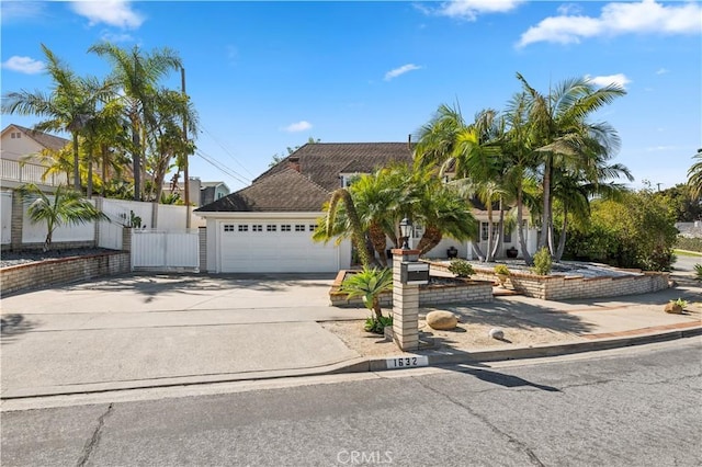 1632 Indus St, Newport Beach, CA 92660 - view of front facade with concrete driveway, an attached garage, and fence