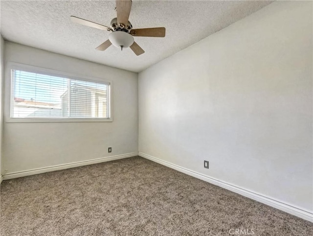 carpeted spare room featuring ceiling fan, baseboards, and a textured ceiling