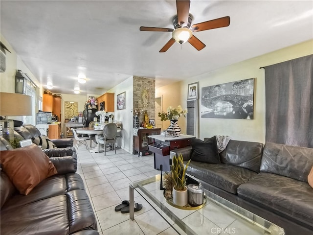 living room featuring light tile patterned floors and a ceiling fan