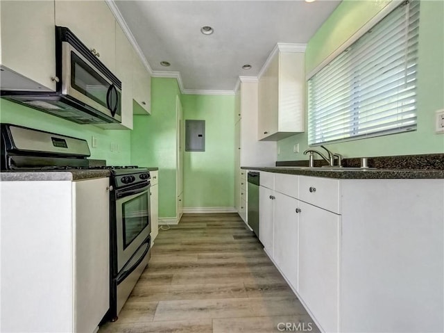 kitchen featuring stainless steel appliances, dark countertops, white cabinets, and ornamental molding