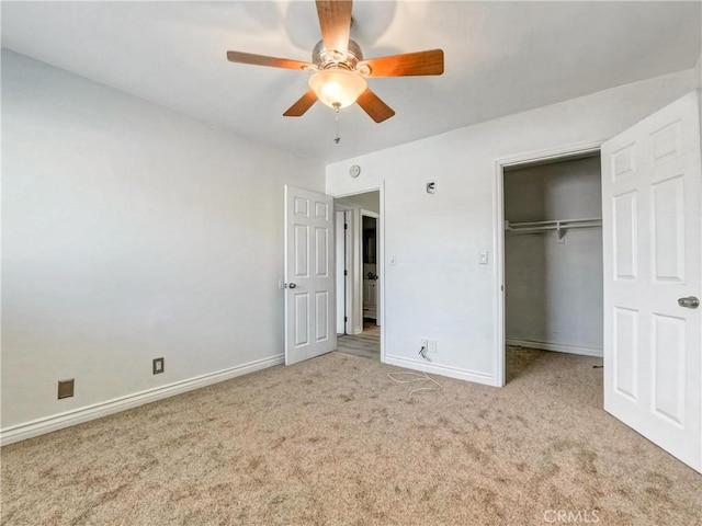 unfurnished bedroom featuring a closet, baseboards, a ceiling fan, and light colored carpet