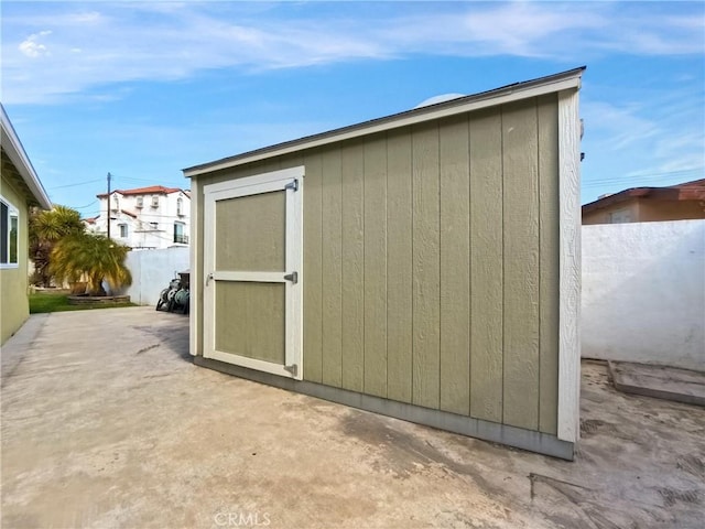 view of shed featuring fence