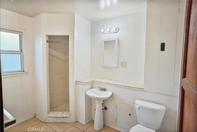 full bath with toilet, a shower stall, and tile patterned flooring