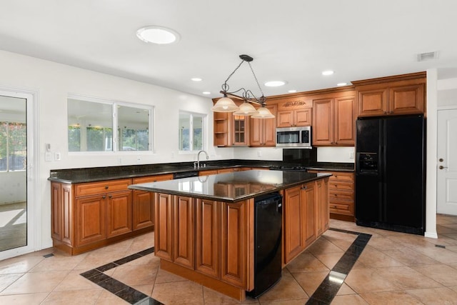 kitchen with brown cabinetry, stainless steel microwave, a center island, hanging light fixtures, and black refrigerator with ice dispenser