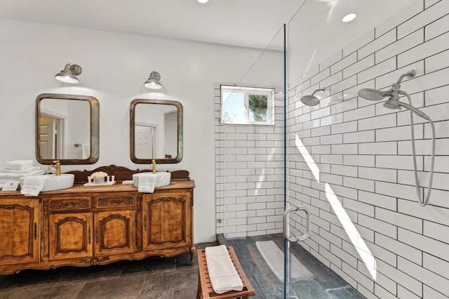 full bath featuring recessed lighting, a shower stall, and double vanity