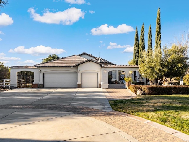 view of front of property featuring a front yard, concrete driveway, an attached garage, and stucco siding