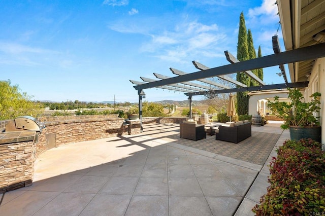 view of patio / terrace with an outdoor living space with a fire pit, an outdoor kitchen, and a pergola