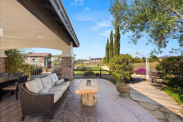 view of patio featuring fence and an outdoor living space