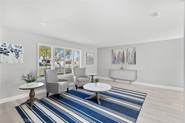 sitting room with light wood-style flooring and baseboards