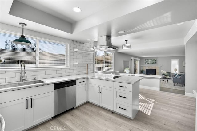 kitchen with a sink, white cabinetry, dishwasher, and decorative light fixtures