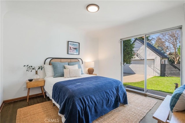 bedroom with access to outside, baseboards, and dark wood-style flooring