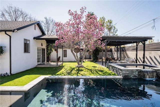 back of house featuring an in ground hot tub, stucco siding, a fenced backyard, and a pergola