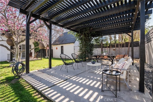 view of patio with outdoor dining area, fence, and a pergola