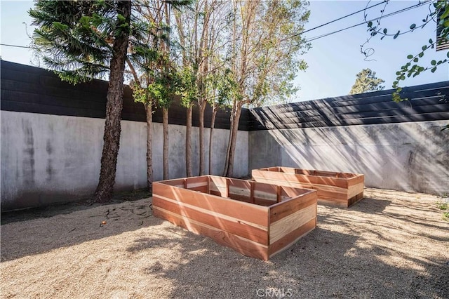 details featuring fence and a vegetable garden