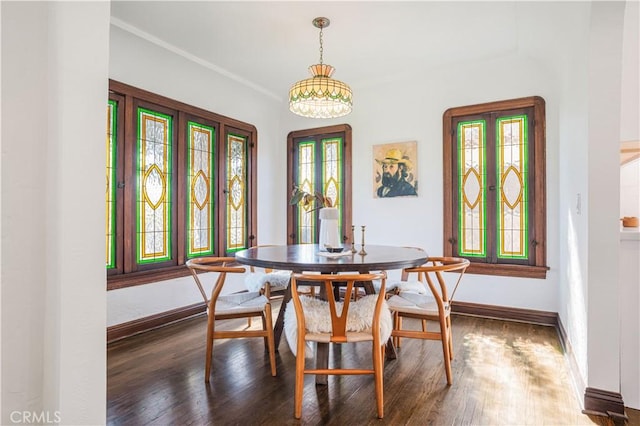 dining space with dark wood-type flooring and baseboards