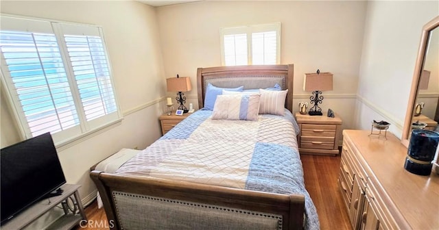 bedroom with dark wood-style floors