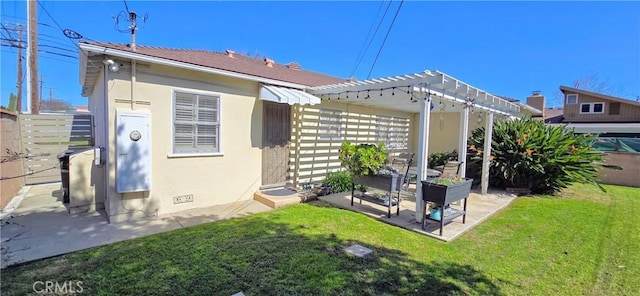 back of property with crawl space, a patio area, a yard, and a pergola