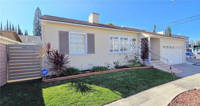 view of front of property featuring a garage, driveway, a chimney, a front lawn, and stucco siding