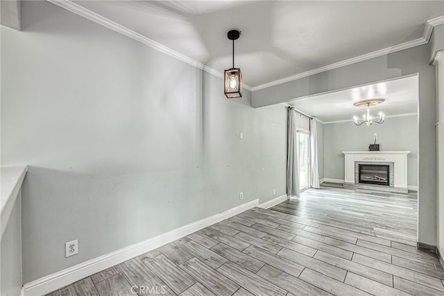 interior space with ornamental molding, wood finish floors, and a fireplace