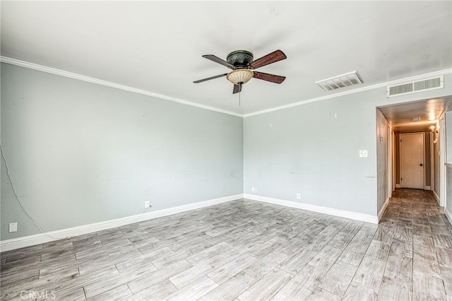 unfurnished room with ornamental molding, baseboards, visible vents, and light wood finished floors