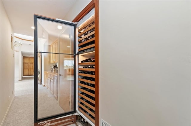 wine area featuring carpet floors and baseboards