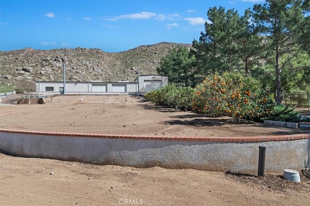 view of yard featuring fence and a mountain view